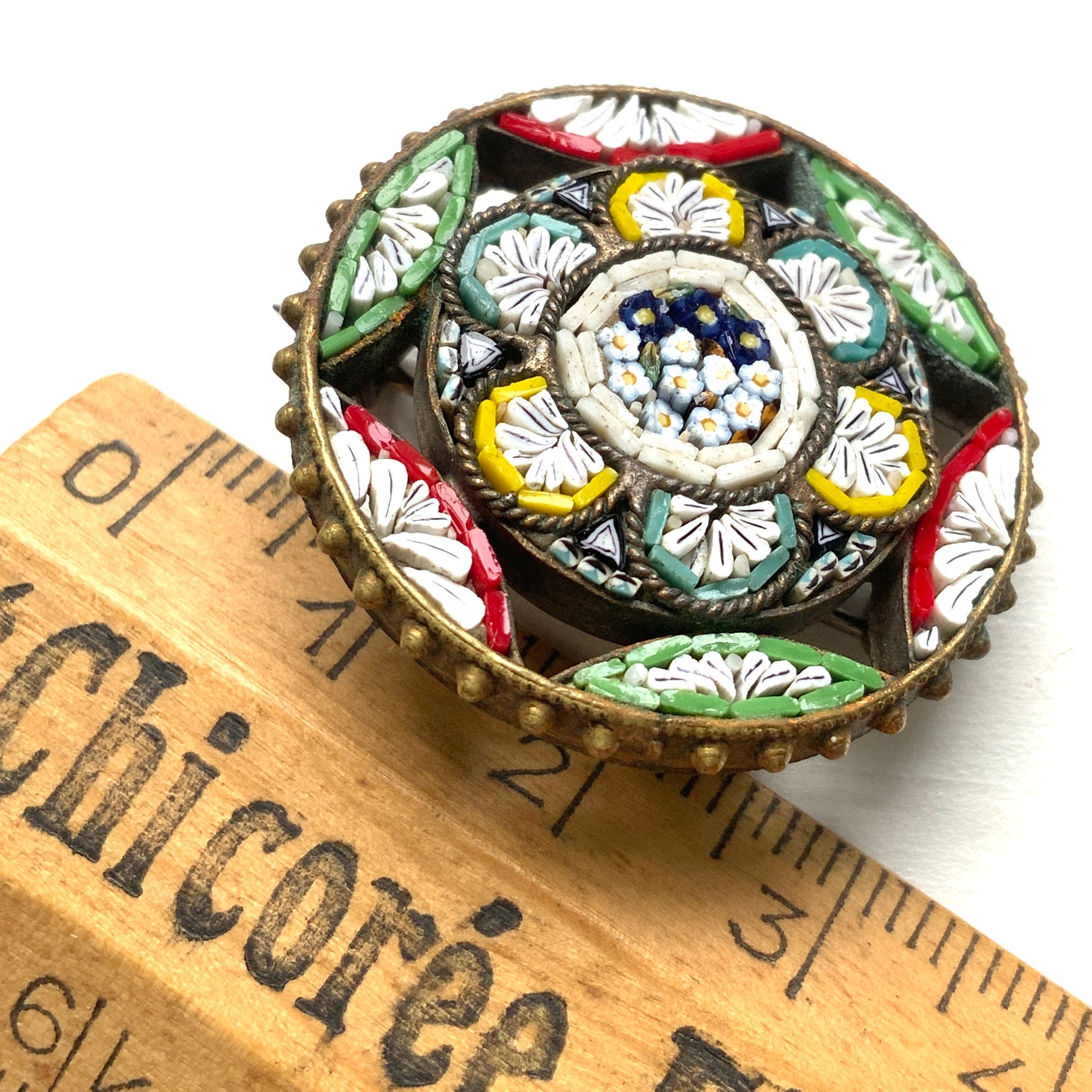 A colourful micro mosaic brooch with delicate openwork details. オープンワークが施された、カラフルなマイクロモザイクのブローチ。