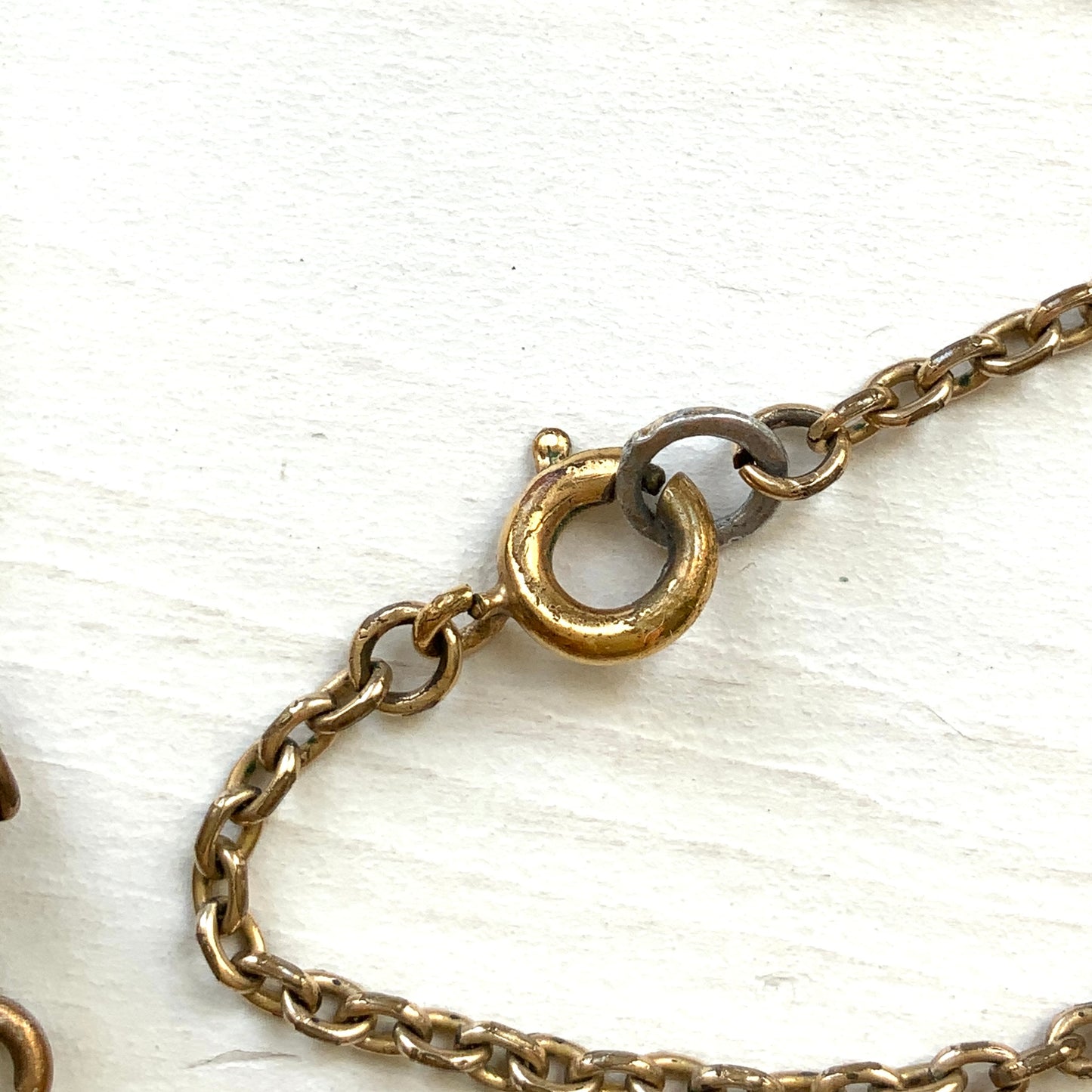 An antique pendant necklace featuring a starburst design with a mysterious glass stone known as Saphiret set in the centre. 神秘的な輝きを放つサフィレットを中央に添えた、ラインストーンのスターバーストデザインのペンダントネックレス。