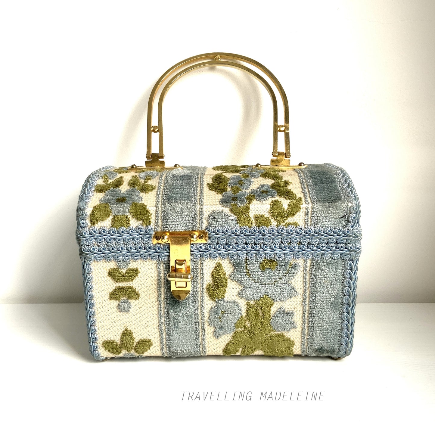 A charming box bag adorned with blue chenille fabric featuring lovely little flowers. ブルーのかわいらしいお花のシェニール生地が貼られたボックスバッグ。
