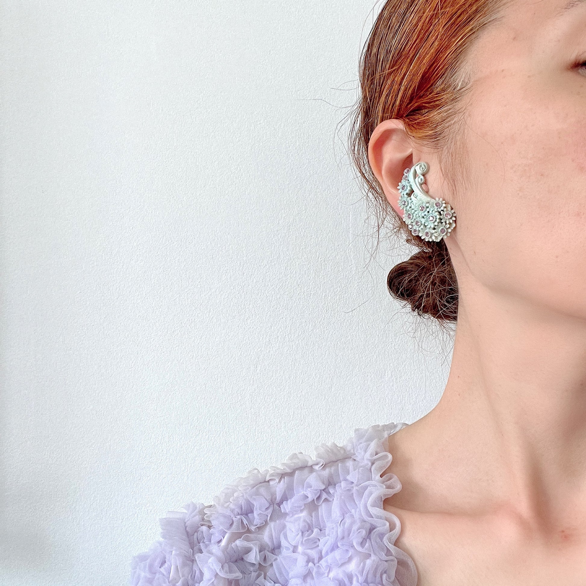 Adorable paisley-shaped clip-on earrings made of pale blue celluloid, adorned with flowers.  かわいいお花が散りばめられた、淡い水色のセルロイド のペイズリー型のクリップイヤリング。