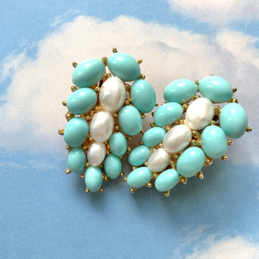 A Trifari dress clip featuring a pure white faux baroque pearl, beautifully framed by pastel turquoise plastic cabochons. ピュアホワイトカラーのフォーバロックパール を、パステルターコイズのプラスチックカボションが囲んでいる、トリファリのドレスクリップ。
