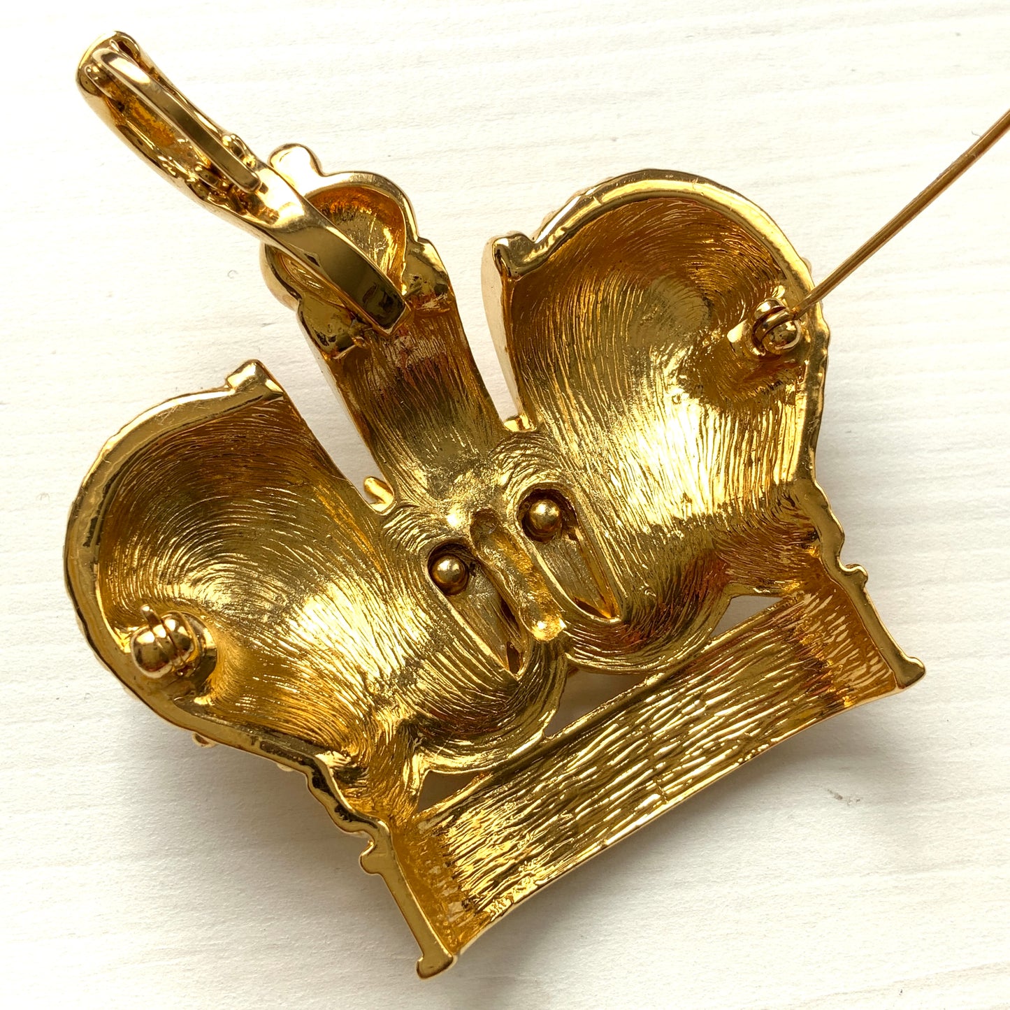 A crown brooch adorned with pearl cabochons and clear rhinestones on gold-tone metal. ゴールドトーンメタルに、パールカボションやクリアラインストーンがふんだんにあしらわれたクラウンブローチ。