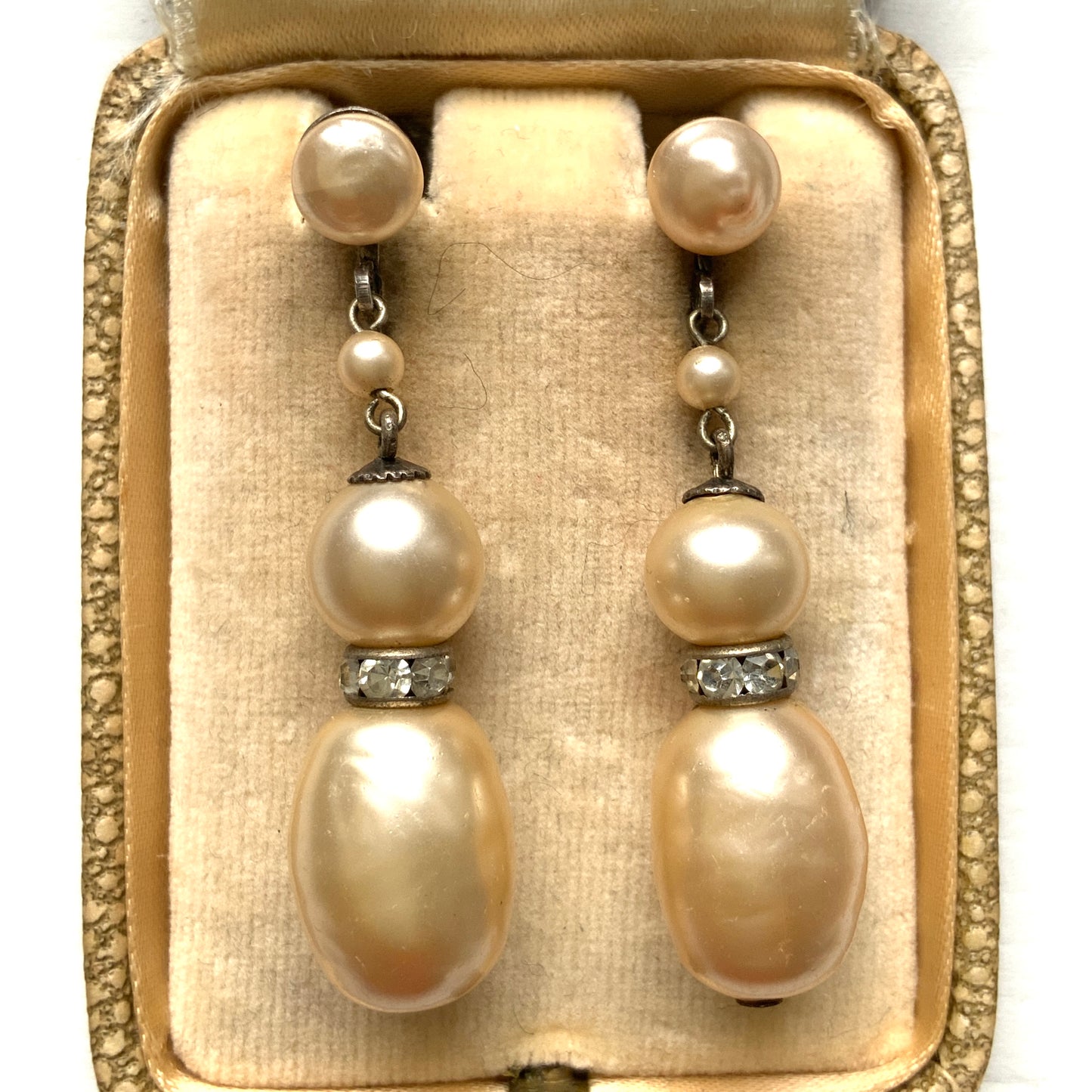 Cream-coloured glass pearls dangle from these screw-back earrings. クリームカラーのグラスパールがゆれるスクリューイヤリング。