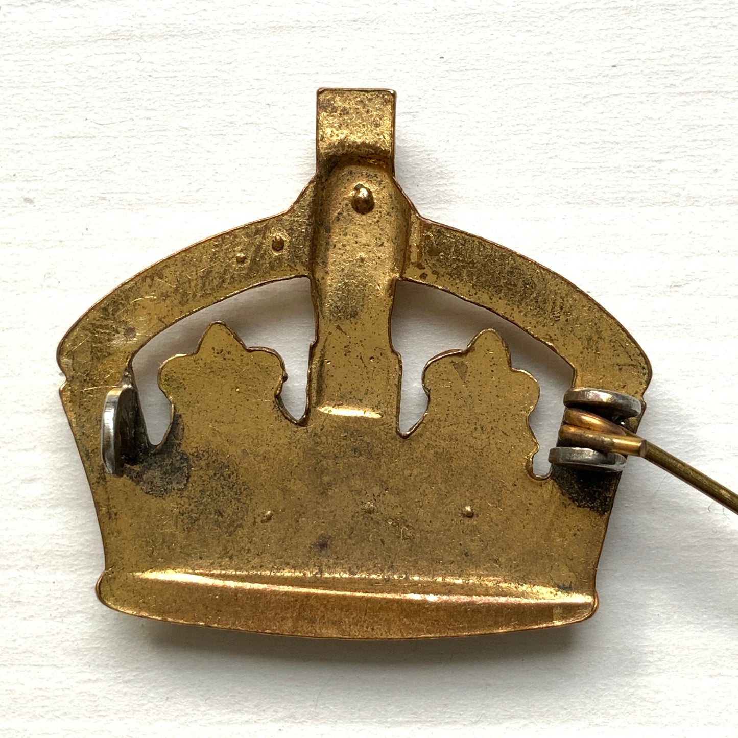 A gold-tone metal crown brooch adorned with clear rhinestones. ゴールドトーンメタルのクラウンに、クリアラインストーンがあしらわれたブローチ。