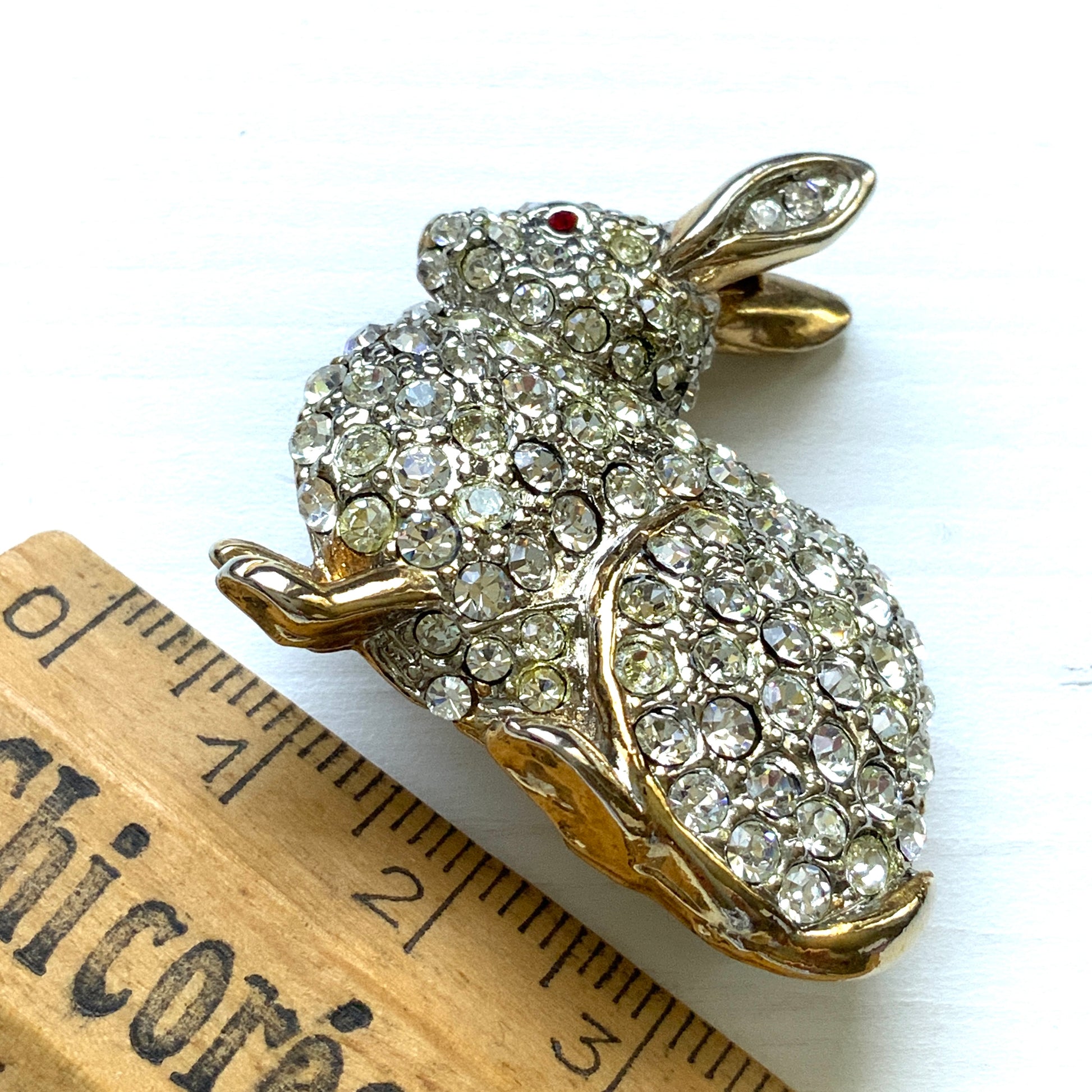 A brooch featuring a rabbit with a plump body adorned with scattered clear rhinestones. ふっくらとしたボディにクリアラインストーンが散りばめられたうさぎのブローチ。
