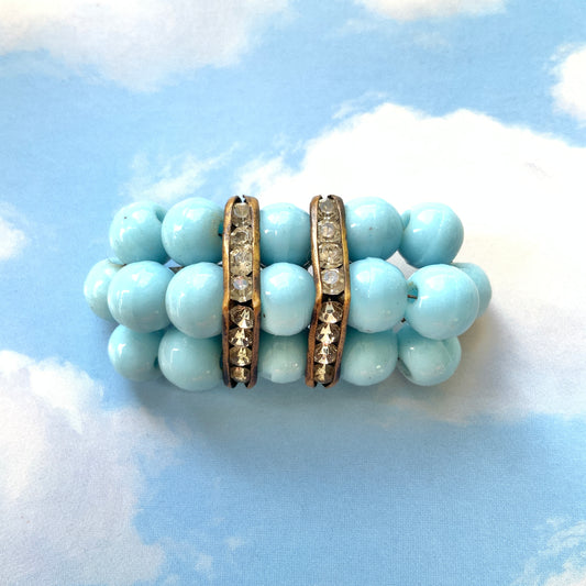 A brooch featuring baby blue glass ball beads arranged in a rectangular pattern.  ベビーブルーのグラスボールビーズが長方形に並んだブローチ。