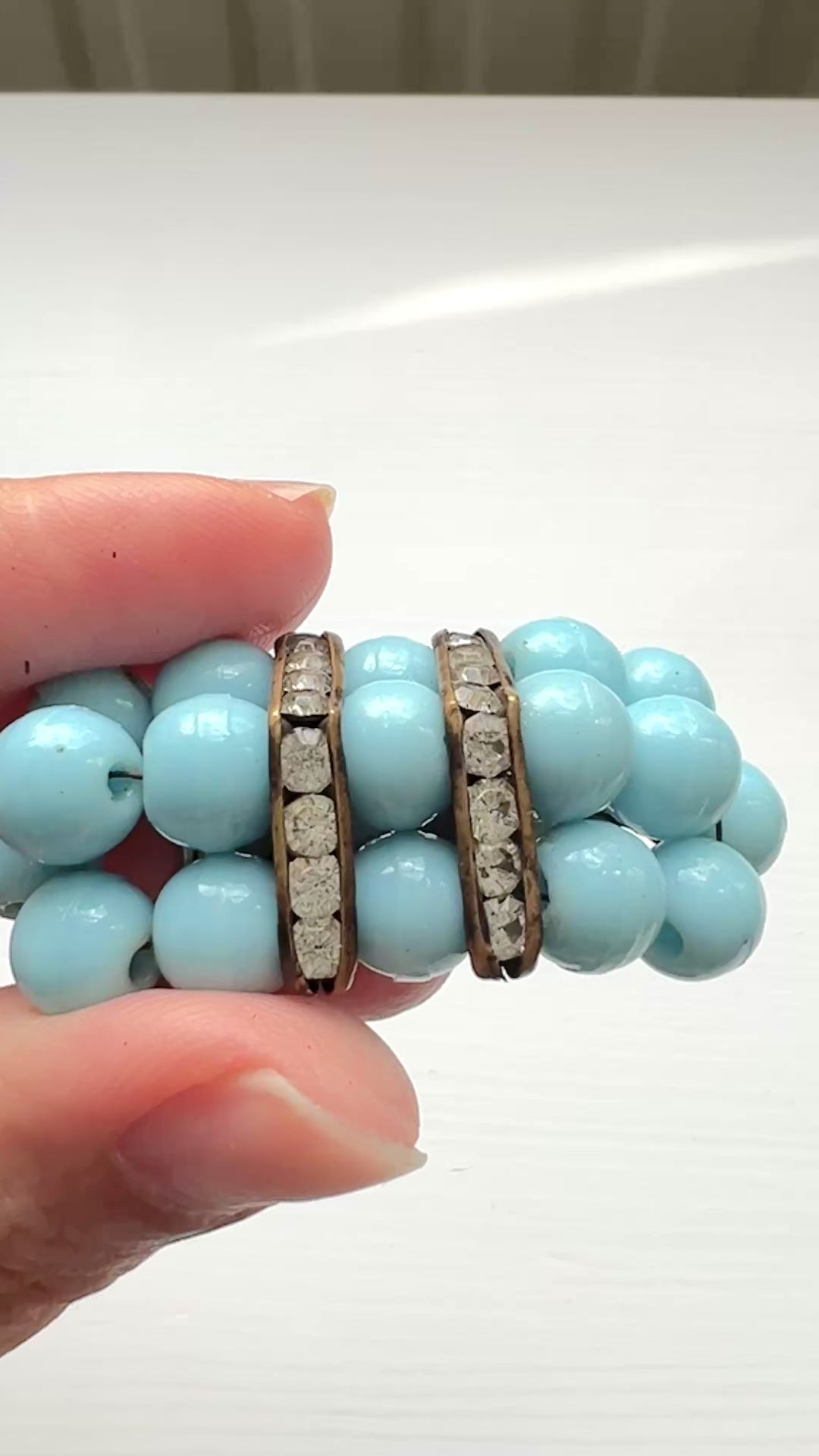 A brooch featuring baby blue glass ball beads arranged in a rectangular pattern.  ベビーブルーのグラスボールビーズが長方形に並んだブローチ。