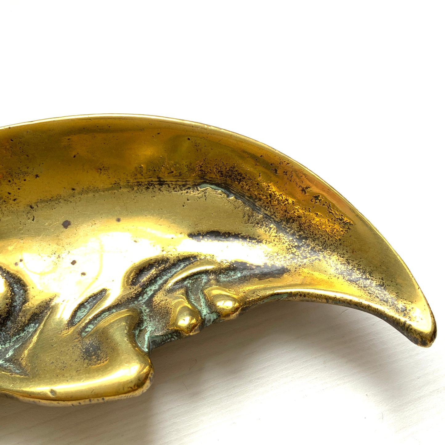 A vintage brass crescent moon ashtray featuring a serene expression. 穏やかな表情を浮かべた三日月が印象的なヴィンテージの真鍮製アッシュトレイ。