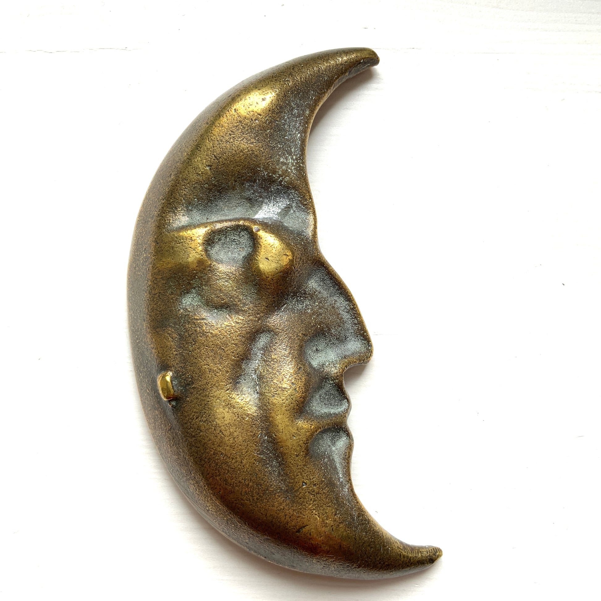 A vintage brass crescent moon ashtray featuring a serene expression. 穏やかな表情を浮かべた三日月が印象的なヴィンテージの真鍮製アッシュトレイ。