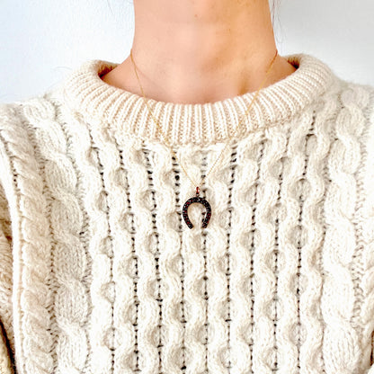 A Victorian horseshoe charm set with garnets. ガーネットが連なる、ヴィクトリア時代の馬蹄モチーフチャーム。