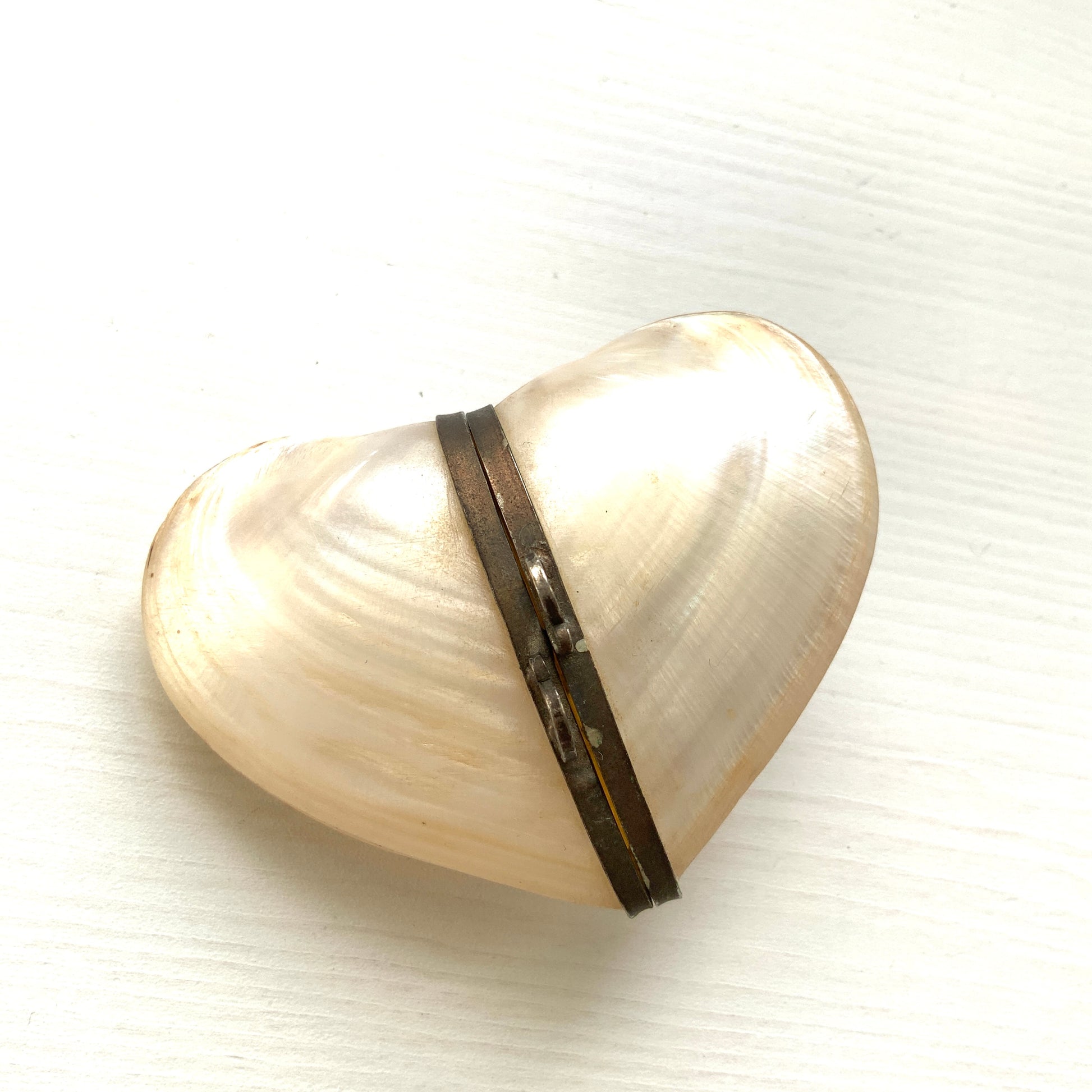 A small heart-shaped box made from mother of pearl. マザーオブパールでできた、ハート型の小さなボックスケース。
