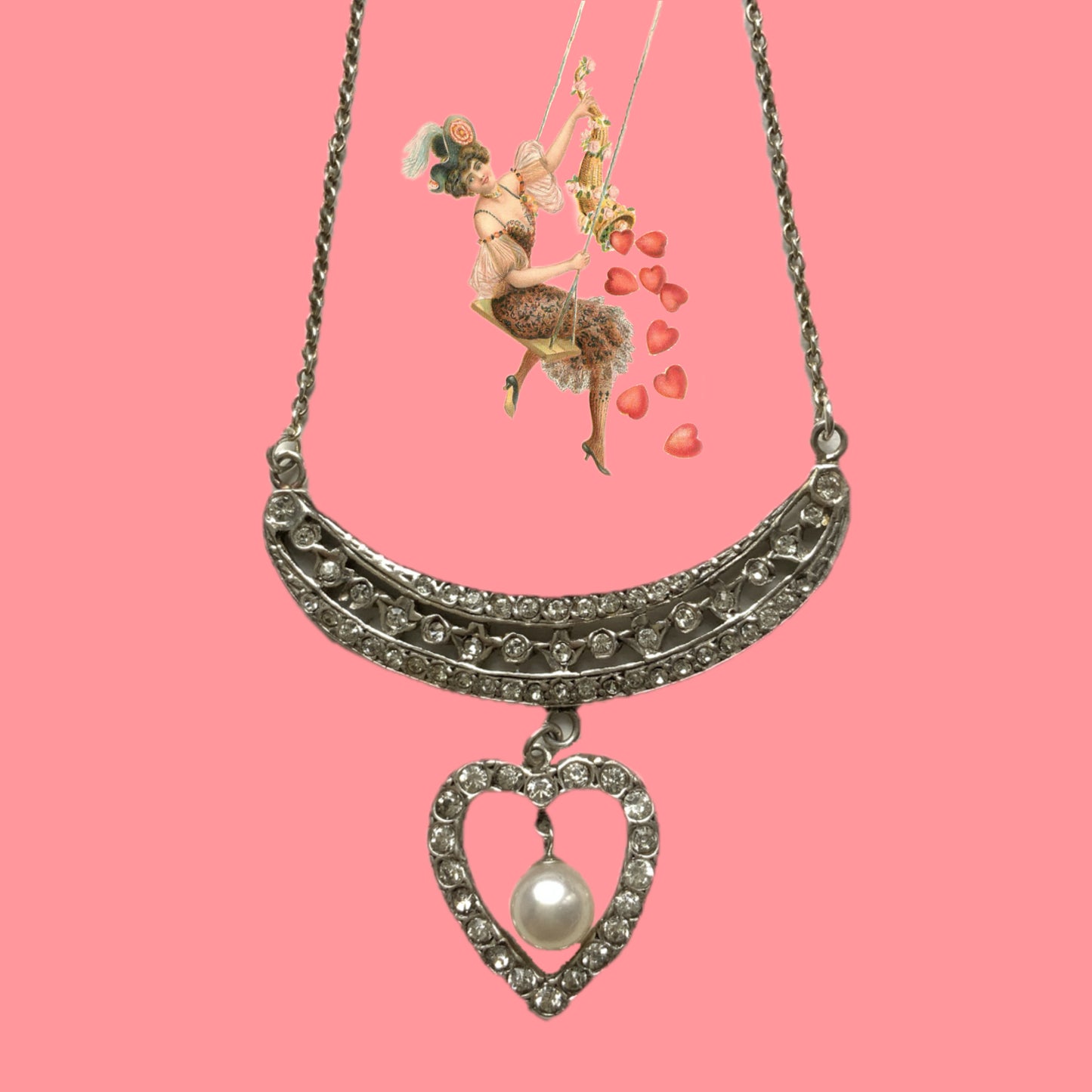 A silver pendant necklace featuring a crescent bar and heart motif.  クレセントバーとハートモチーフのシルバーペンダントネックレス。 