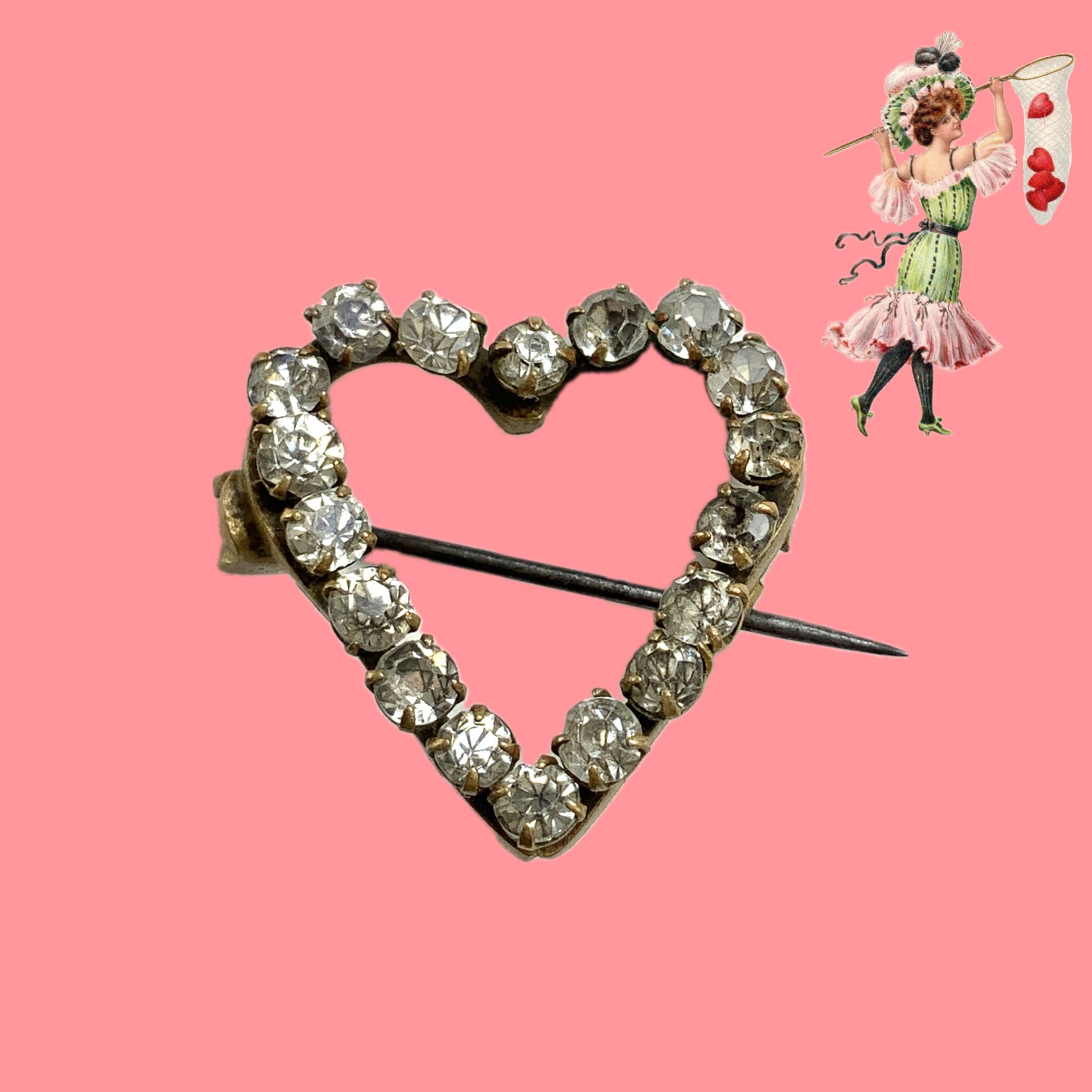 A mini open-heart brooch set with clear rhinestones. クリアラインストーンを連ねた、オープンハートのミニブローチ。