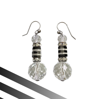 Art Deco vintage earrings featuring large faceted glass beads, striped black and clear glass elements, and sparkling rhinestone-set spacers. アールデコのヴィンテージピアス。