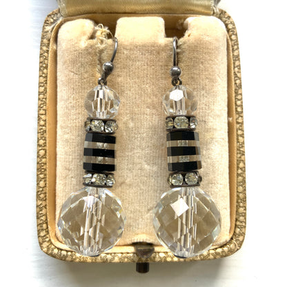 Art Deco vintage earrings featuring large faceted glass beads, striped black and clear glass elements, and sparkling rhinestone-set spacers. アールデコのヴィンテージピアス。