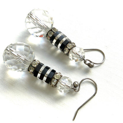 Art Deco vintage earrings featuring large faceted glass beads, striped black and clear glass elements, and sparkling rhinestone-set spacers. アールデコのヴィンテージピアス。