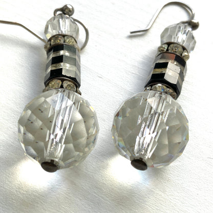 Art Deco vintage earrings featuring large faceted glass beads, striped black and clear glass elements, and sparkling rhinestone-set spacers. アールデコのヴィンテージピアス。