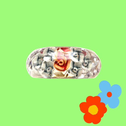 A vintage lucite bangle featuring carved and painted rose intaglios. クリアルーサイトに薔薇のインタリオが施されたヴィンテージバングル。