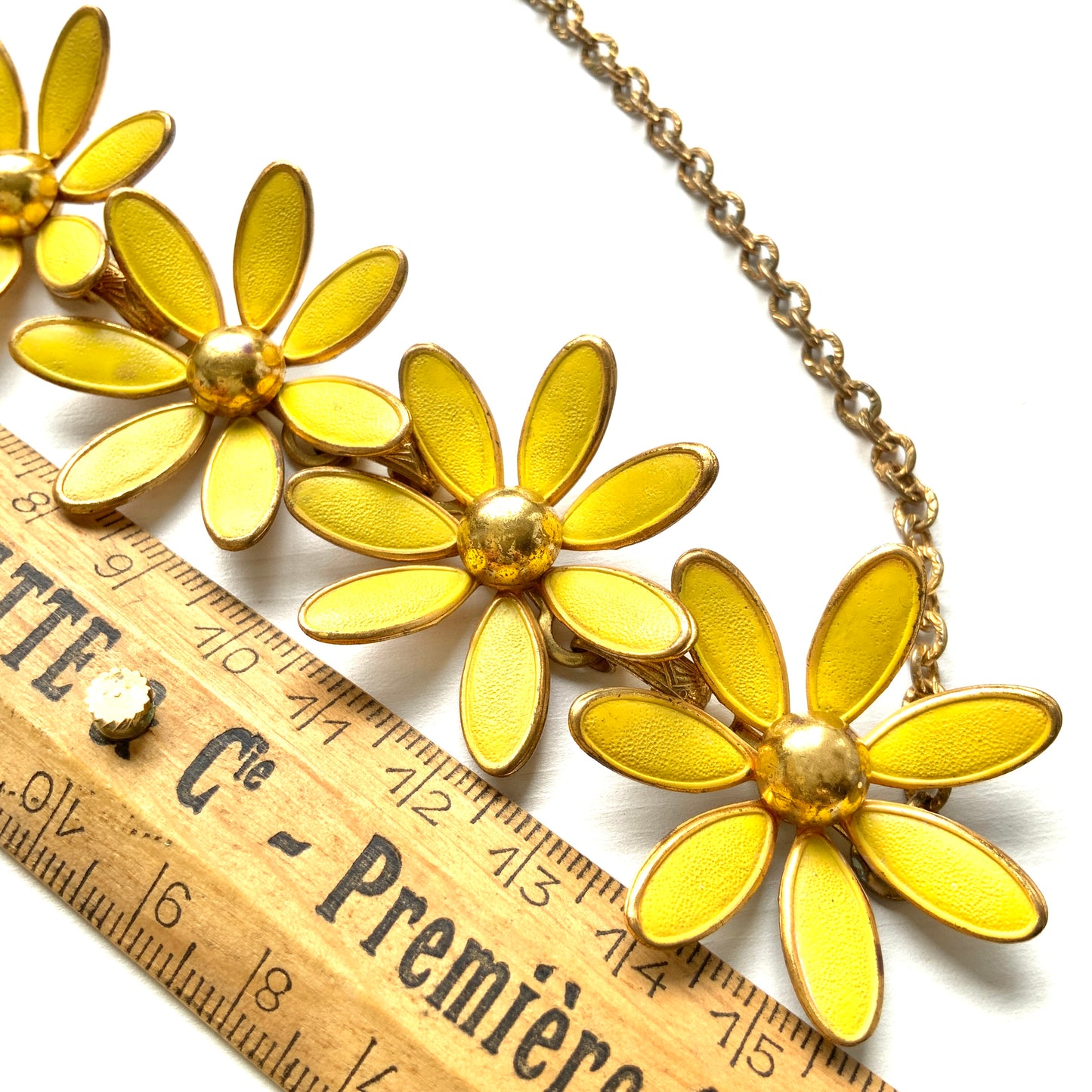 A vintage necklace featuring linked yellow enamel flowers. イエローのエナメルフラワーが連なったヴィンテージネックレス。