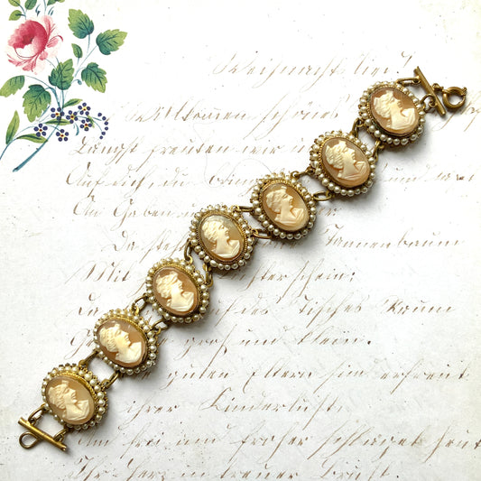 A bracelet lavishly set with seven shell cameos, each delicately framed with tiny glass pearls.  七つのシェルカメオを贅沢に連ねたブレスレット。 