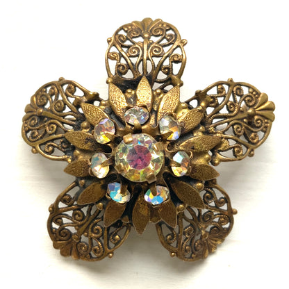 A beautifully detailed filigree flower brooch with a softly glowing aurora borealis centre.  フィリグリー×オーロラストーンのフラワーブローチ。