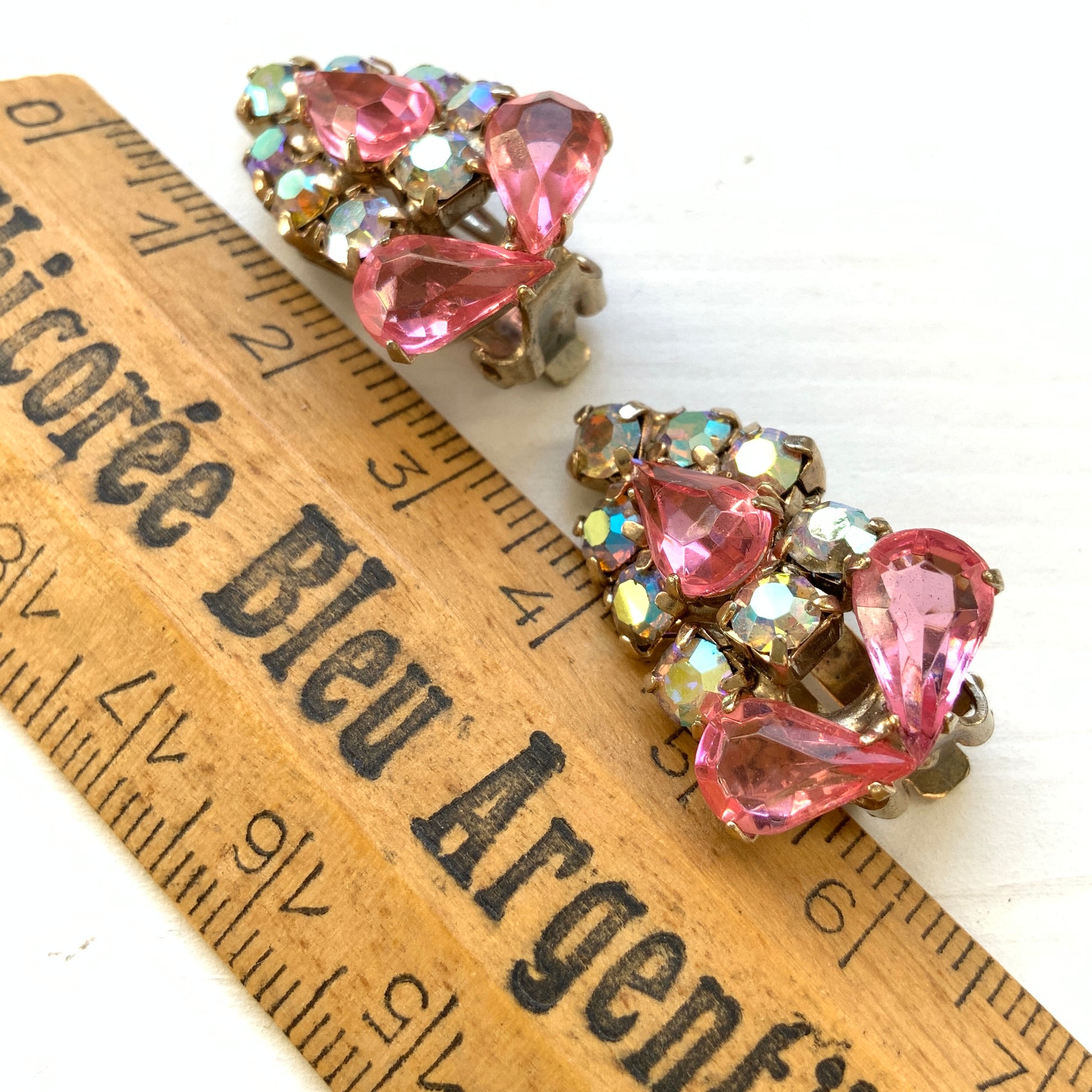 Earrings featuring pink teardrop glass stones paired with aurora rhinestones. ピンクのティアドロップガラスとオーロララインストーンを組み合わせたイヤリング。