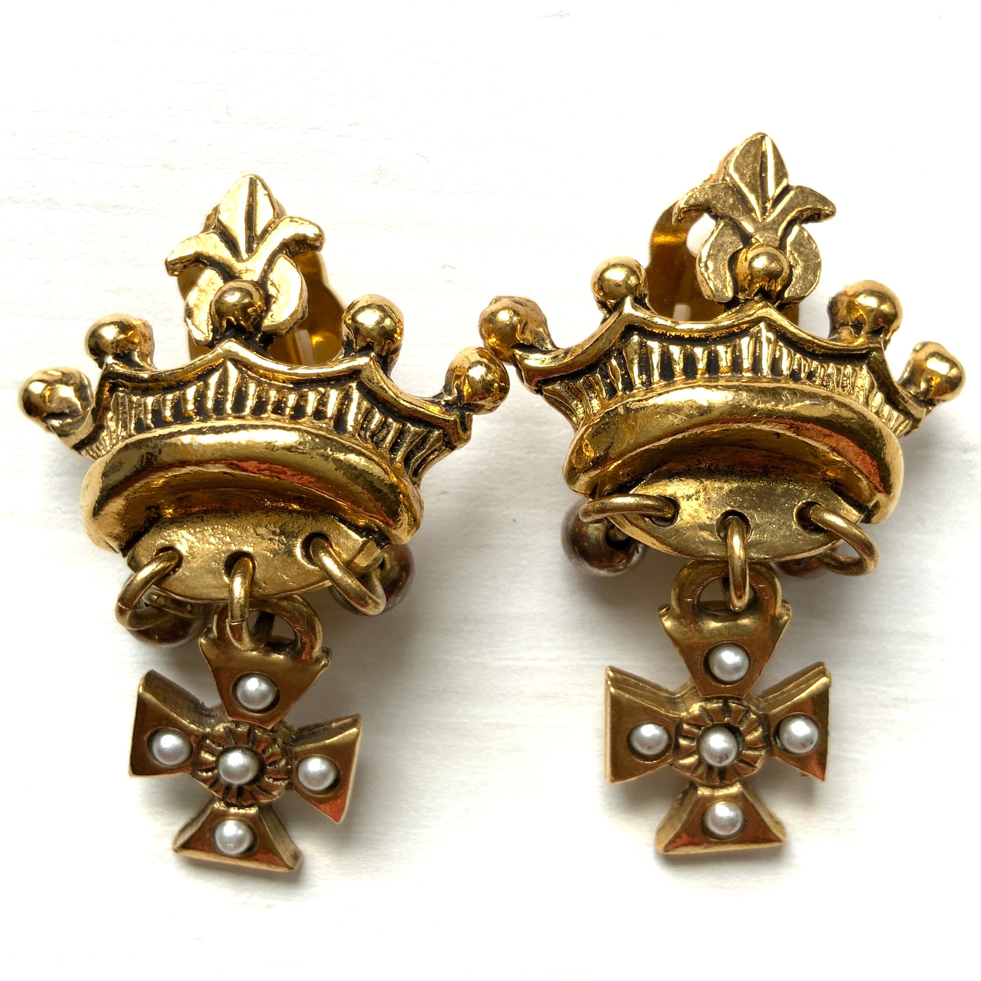 Gold-tone crown clip-on earrings with a Maltese cross charm. ゴールドトーンのクラウンに、マルティーズクロスがゆれるクリップイヤリング。 
