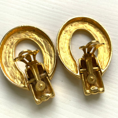 Gold-tone door knocker earrings with subtle linear detailing. ラインが入ったゴールドトーンのドアノッカーイヤリング。 