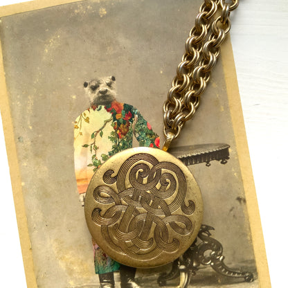 A vintage Monet locket necklace featuring an eye-catching woven-style scroll pattern.  編み込まれたような曲線模様が印象的な、Monet（モネ）のヴィンテージロケットネックレス。