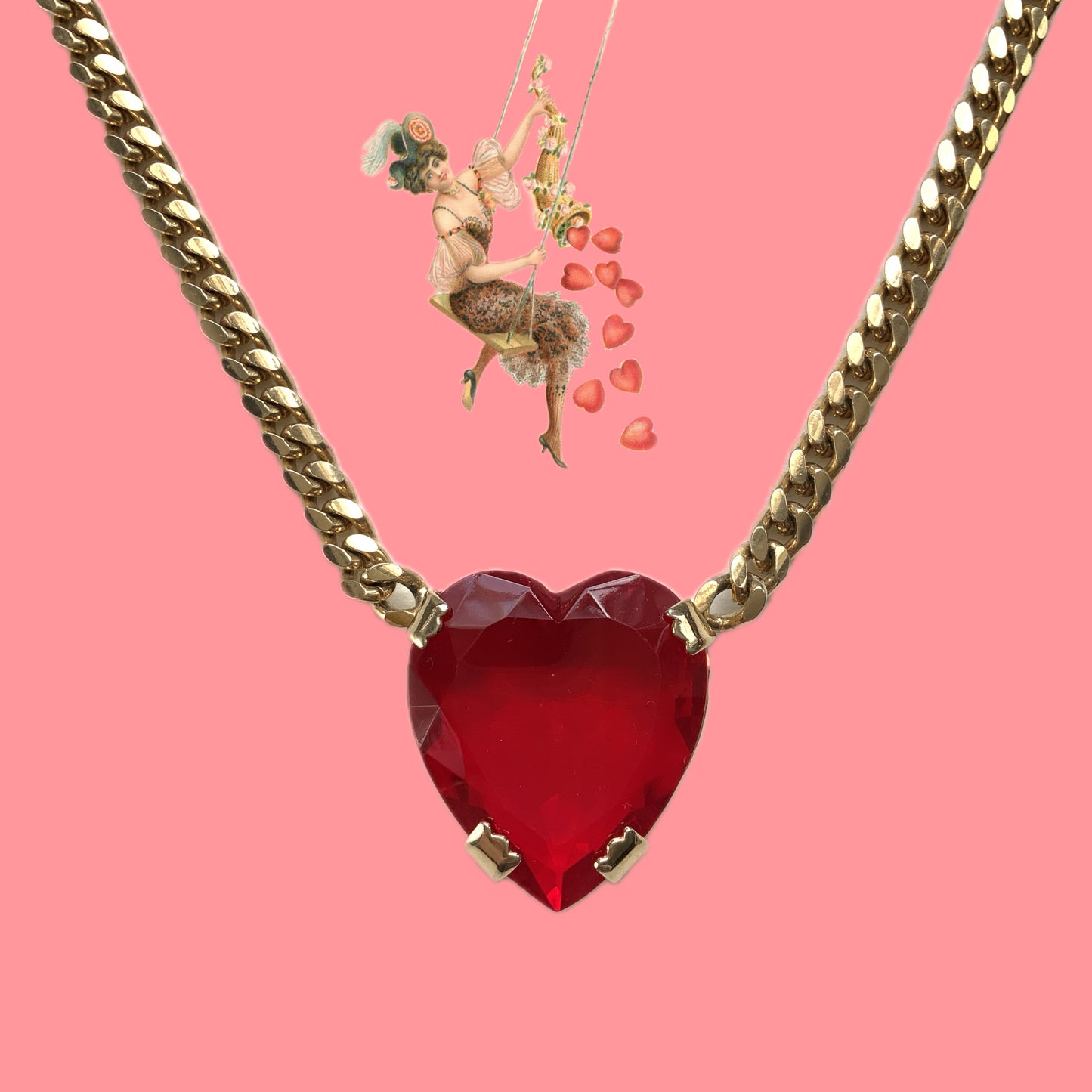 A necklace featuring a large, vibrant red glass heart that immediately draws the eye. 大きく鮮やかなレッドハートのグラスビジューが目を引くネックレス。