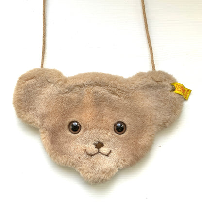A charming Steiff bear-face purse with adorable round eyes and a wonderfully soft, fluffy plush texture.  くりっとした目が愛らしい、クマの顔のポシェット。ふわふわのファー素材で、思わず触りたくなる手触りです。