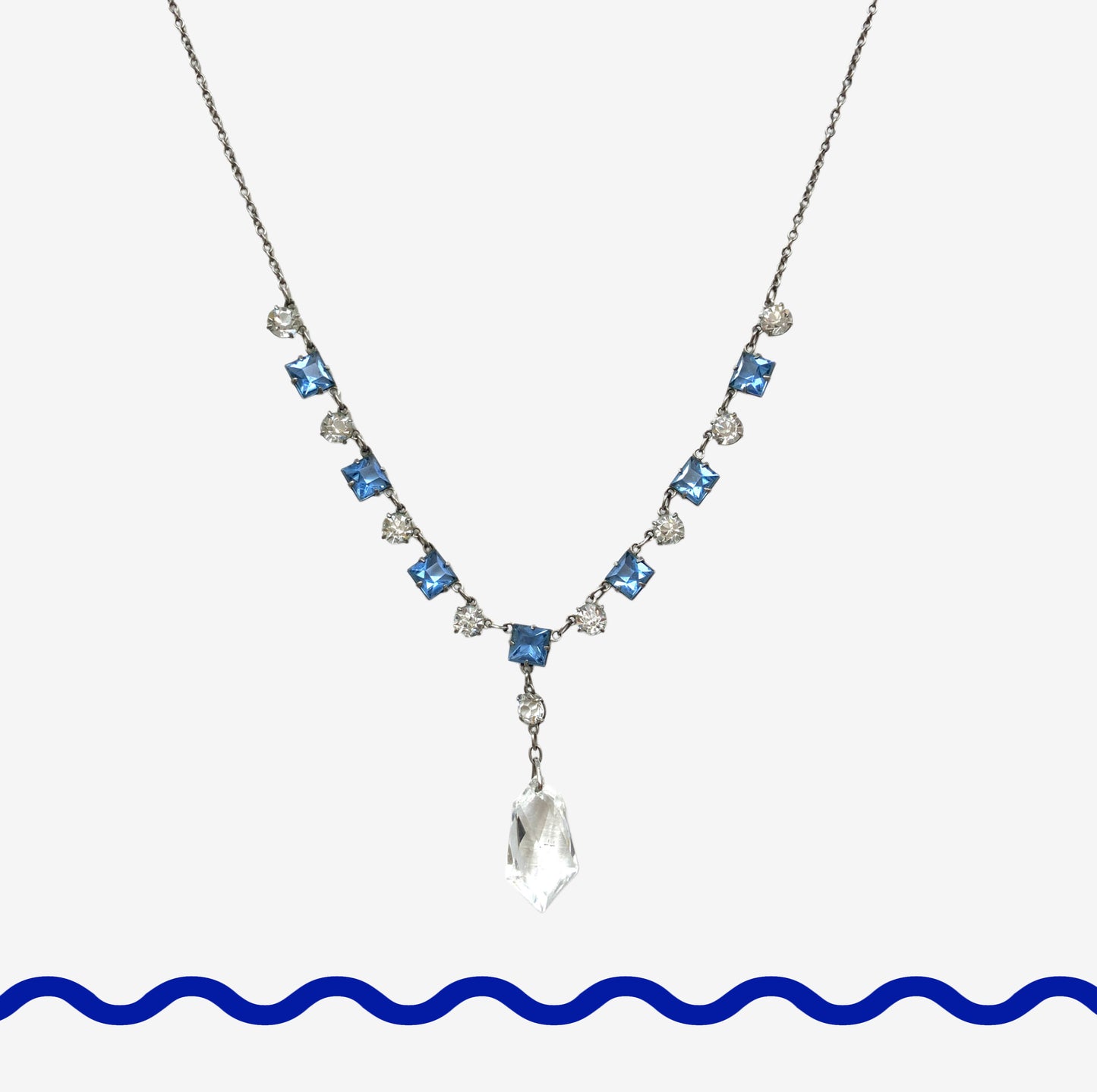 A vintage necklace featuring alternating blue and clear glass stones. ブルーとクリアのグラスを連ねたヴィンテージネックレス。