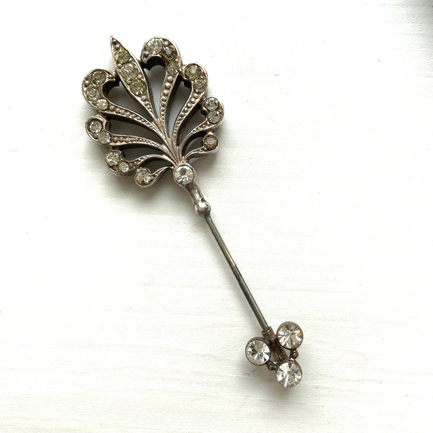 A beautiful jabot pin with a feather-like motif set with clear rhinestones. J クリアラインストーンがあしらわれた、美しい羽のようなモチーフのジャボットピン。 