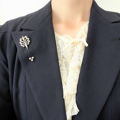 A beautiful jabot pin with a feather-like motif set with clear rhinestones. J クリアラインストーンがあしらわれた、美しい羽のようなモチーフのジャボットピン。 