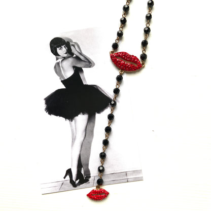 Rosary-style necklace by Butler & Wilson, featuring vivid red lips on a strand of black glass beads.  ブラックグラスビーズに真っ赤な唇をあしらった、バトラー＆ウィルソンのロザリオネックレス。