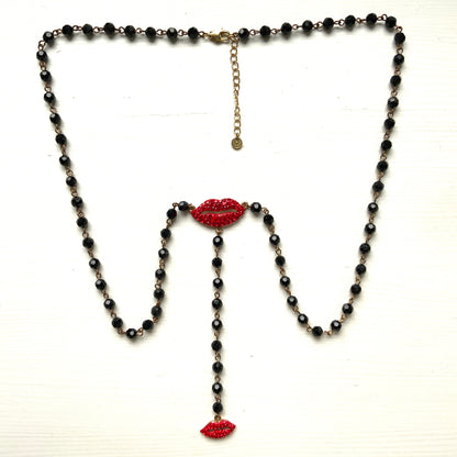 Rosary-style necklace by Butler & Wilson, featuring vivid red lips on a strand of black glass beads.  ブラックグラスビーズに真っ赤な唇をあしらった、バトラー＆ウィルソンのロザリオネックレス。