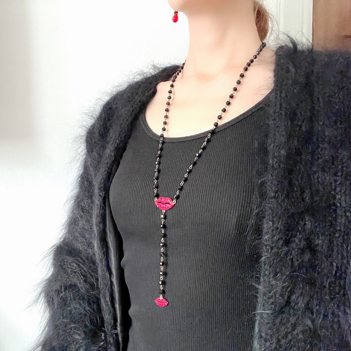 Rosary-style necklace by Butler & Wilson, featuring vivid red lips on a strand of black glass beads.  ブラックグラスビーズに真っ赤な唇をあしらった、バトラー＆ウィルソンのロザリオネックレス。