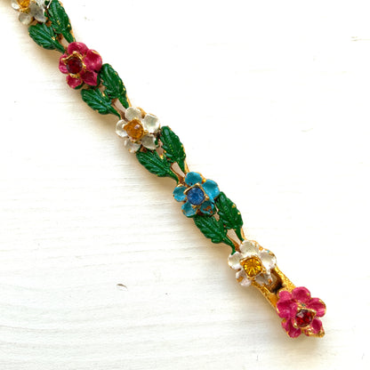 A delicate enamel bracelet adorned with rows of pink, pale blue and white flowers. ピンク、水色、白のお花が並んだエナメルのブレスレット。