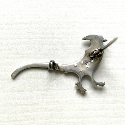 A sterling silver pheasant brooch featuring a beautiful enamel gradient shifting from blue to green.  ブルーからグリーンへと移ろうエナメルのグラデーションが美しい、雉モチーフのシルバーブローチ。