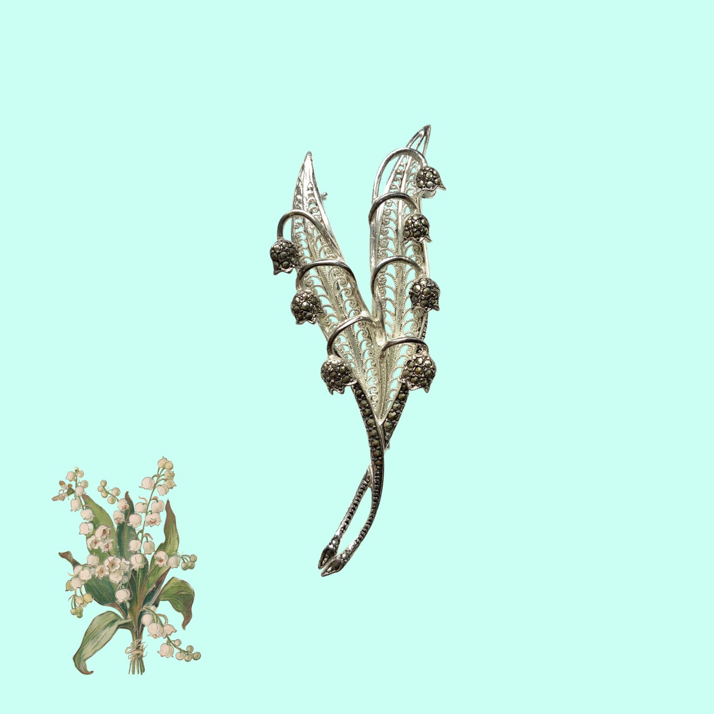 A lily of the valley brooch set with marcasite. マーカサイトがあしらわれたスズランモチーフのブローチ。 