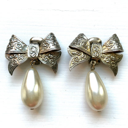 Vintage clip-on earrings featuring a silver-tone bow with large teardrop pearls that gently sway. シルバートーンメタルのリボンに、大きなティアドロップパールが揺れるクリップイヤリング。
