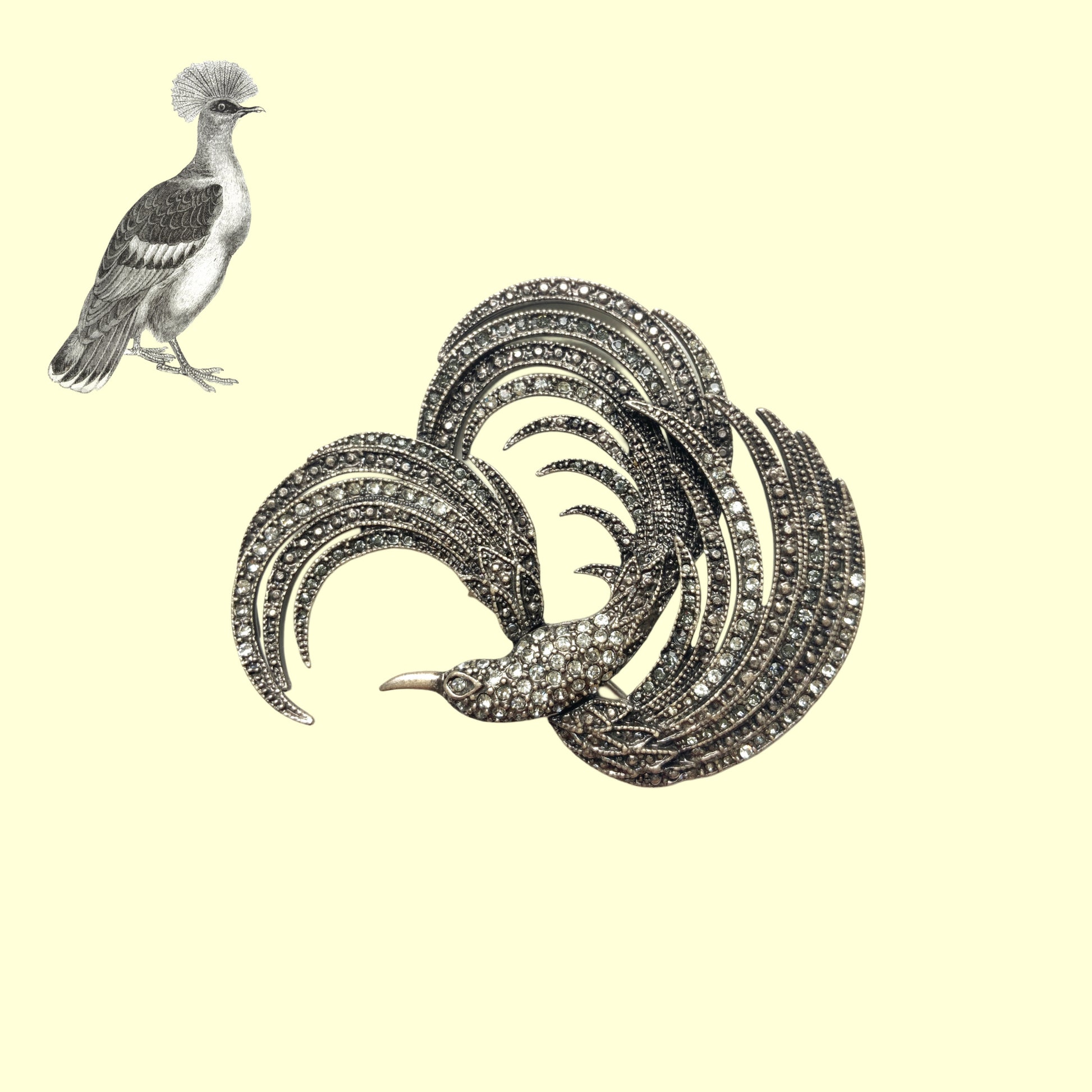 A vintage bird brooch in silver-tone metal, defined by its flowing, sculptural lines. 流れるようなラインが印象的な、鳥モチーフのブローチ。