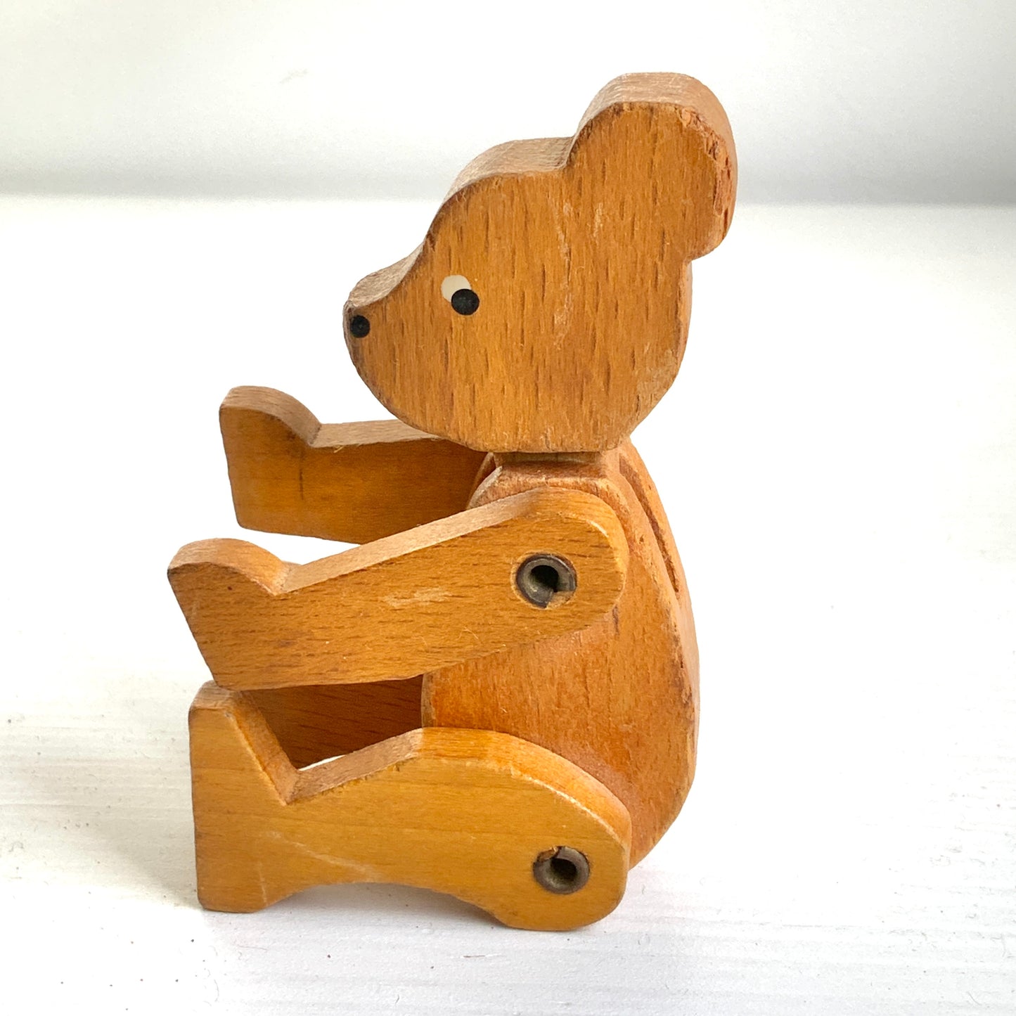 A sweet little wooden bear with wide, curious eyes and a simple, charming expression.キョロっとした目が愛らしい、木製の小さなクマのおもちゃ。