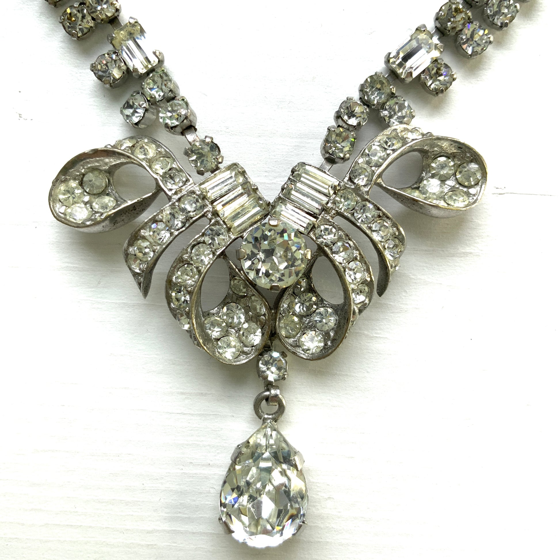 A gorgeous necklace featuring a ribbon-like motif set with clear rhinestones. ゴージャスなクリアラインストーンの、リボンのようなモチーフがついたネックレス。