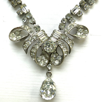 A gorgeous necklace featuring a ribbon-like motif set with clear rhinestones. ゴージャスなクリアラインストーンの、リボンのようなモチーフがついたネックレス。