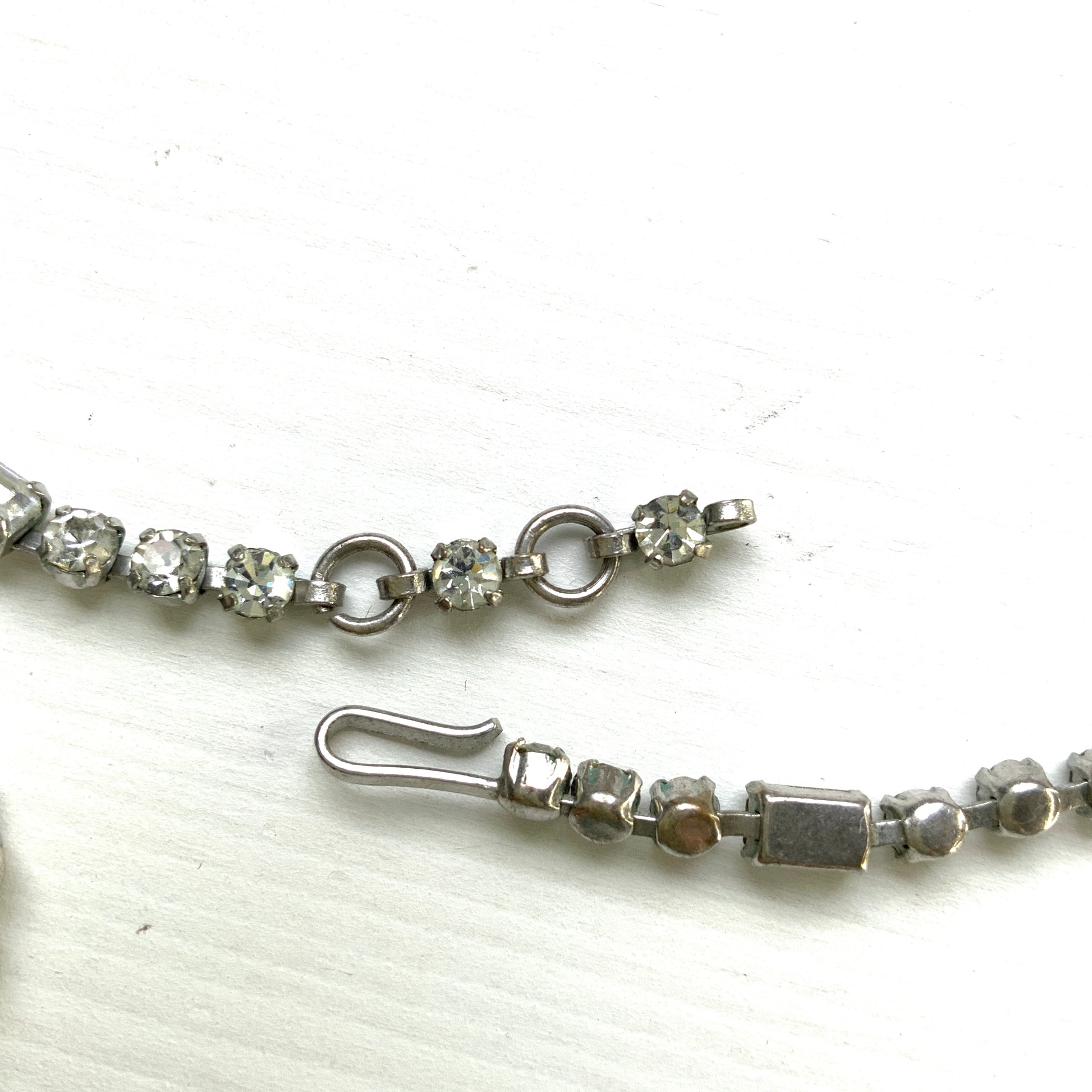 A gorgeous necklace featuring a ribbon-like motif set with clear rhinestones. ゴージャスなクリアラインストーンの、リボンのようなモチーフがついたネックレス。