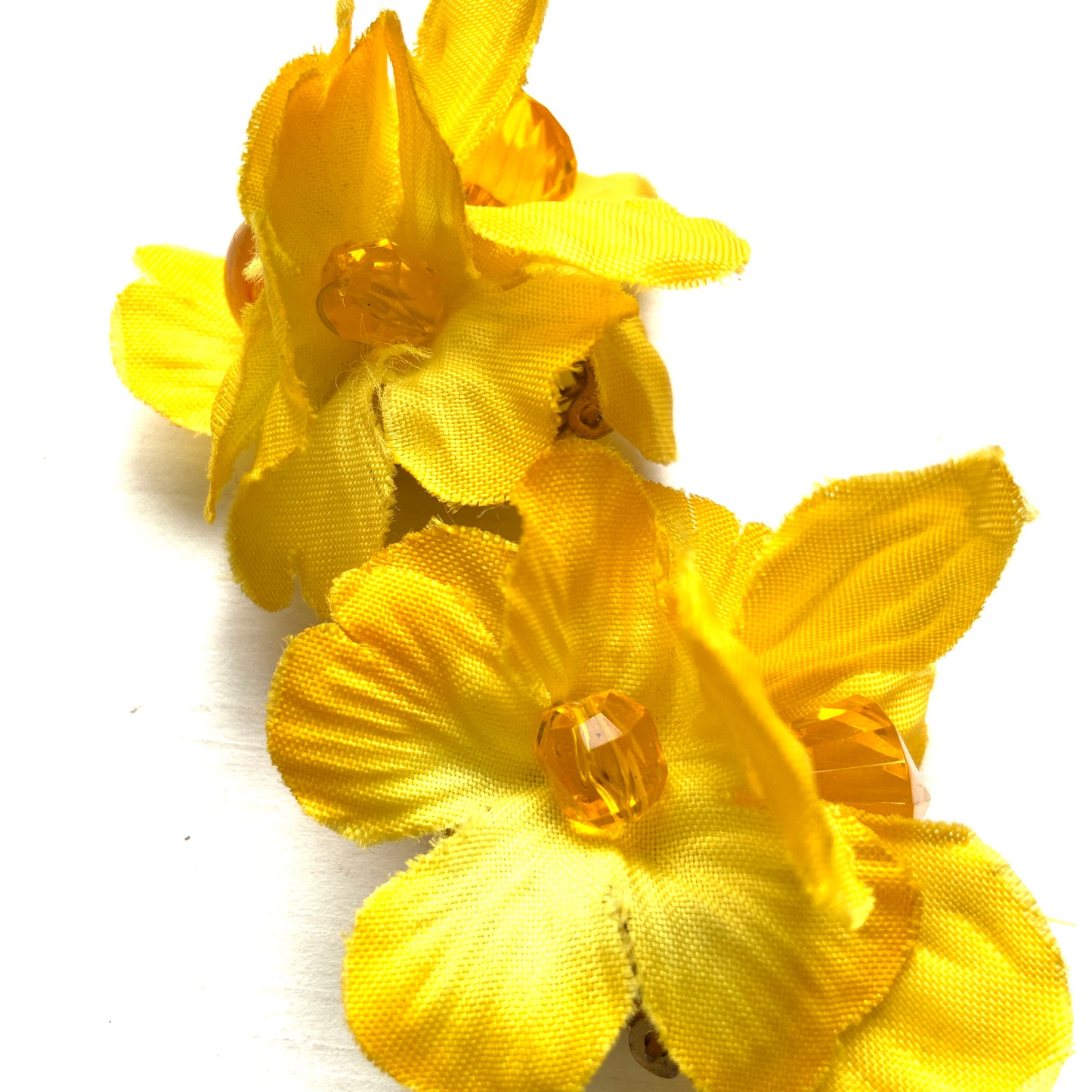 Vintage clip-on earrings featuring bright yellow fabric flowers. ぱっと明るいイエローの布花を使ったヴィンテージのクリップイヤリング。