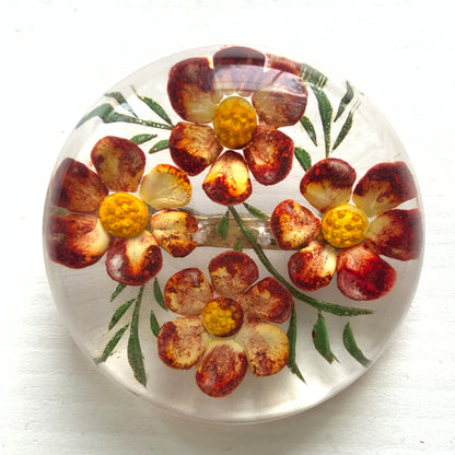 A charming 1950s reverse carved Lucite brooch featuring a vibrant red flower. 1950年代の赤いお花のインタリオブローチ。