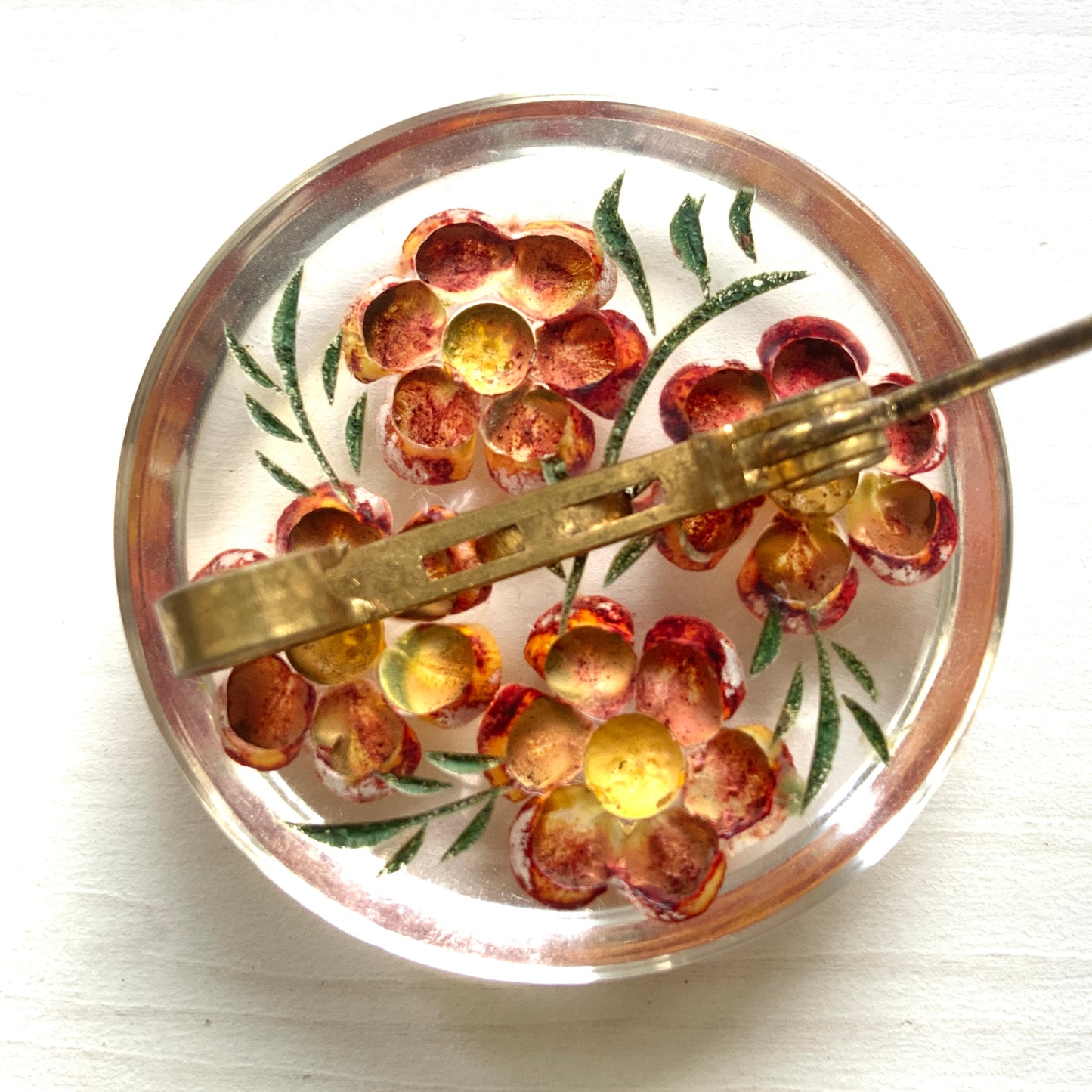A charming 1950s reverse carved Lucite brooch featuring a vibrant red flower. 1950年代の赤いお花のインタリオブローチ。